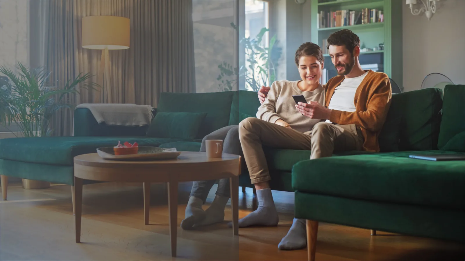 A couple using a phone from the comfort of their home