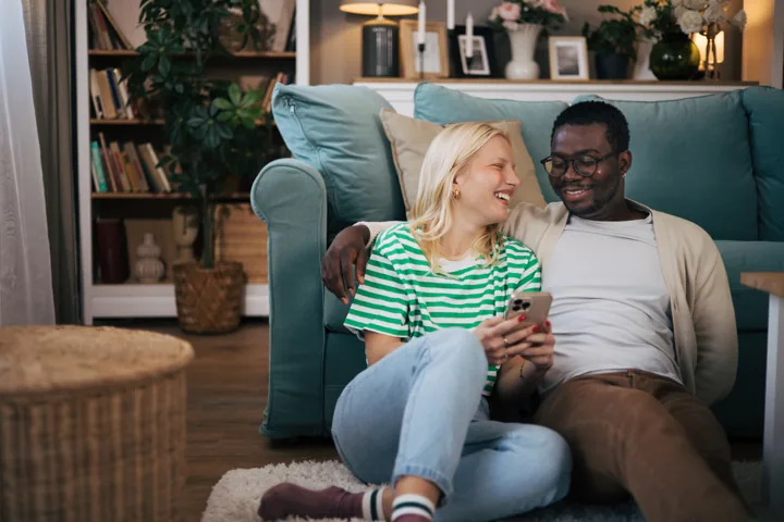 Two people talking on the phone at home